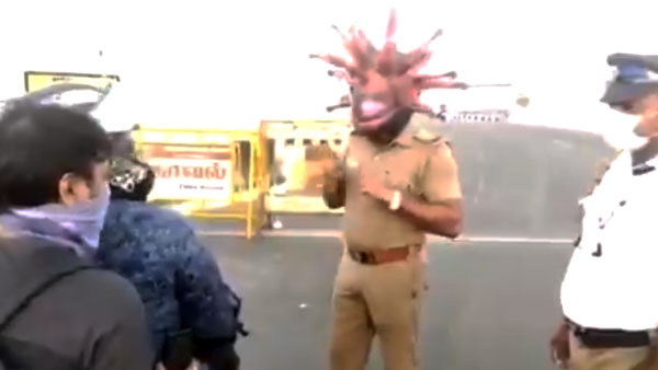 కరోనాపై అవగాహన కల్పించడానికి కరోనా హెల్మెట్ ధరించిన పోలీస్